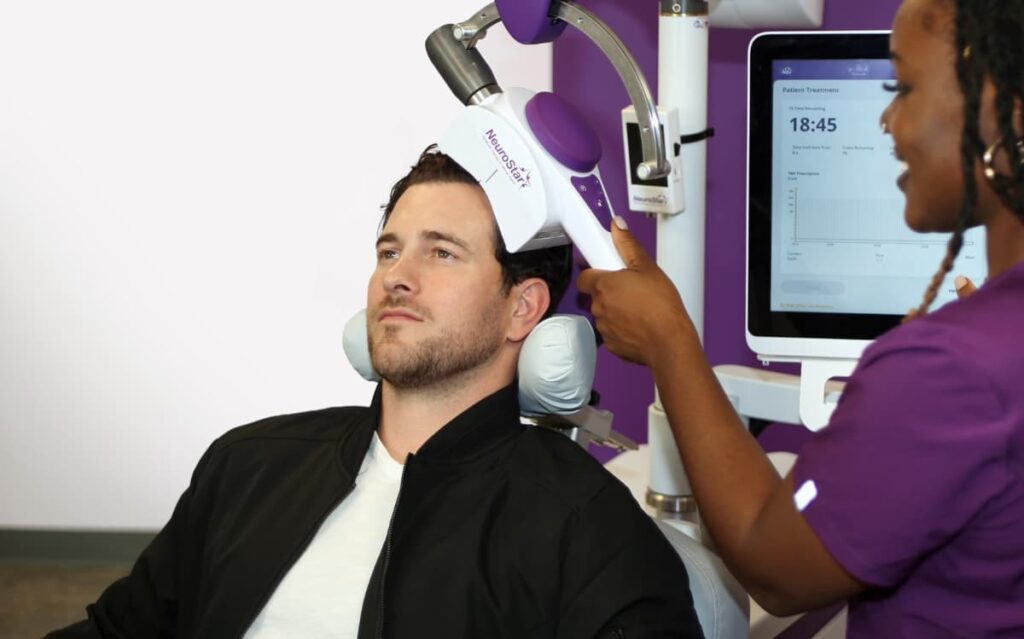 A male patient receiving NeuroStar TMS therapy, showing how can TMS cure depression through targeted brain stimulation. 
